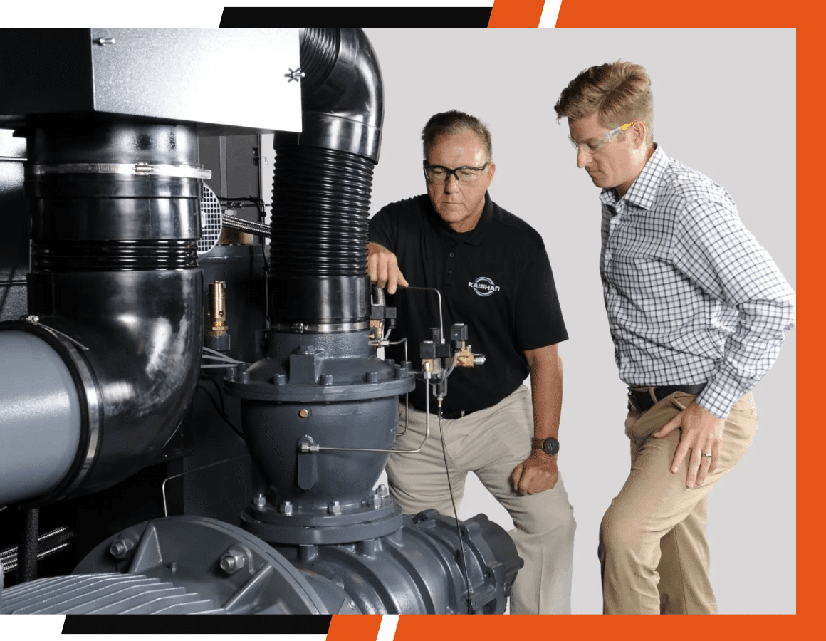 Two men working on air compressor parts