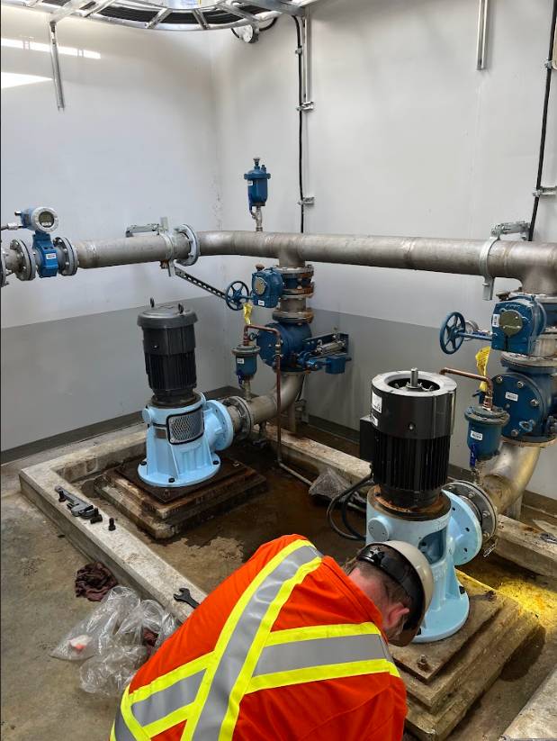 Technician working on the critical pump system during the First Nations infrastructure upgrade.