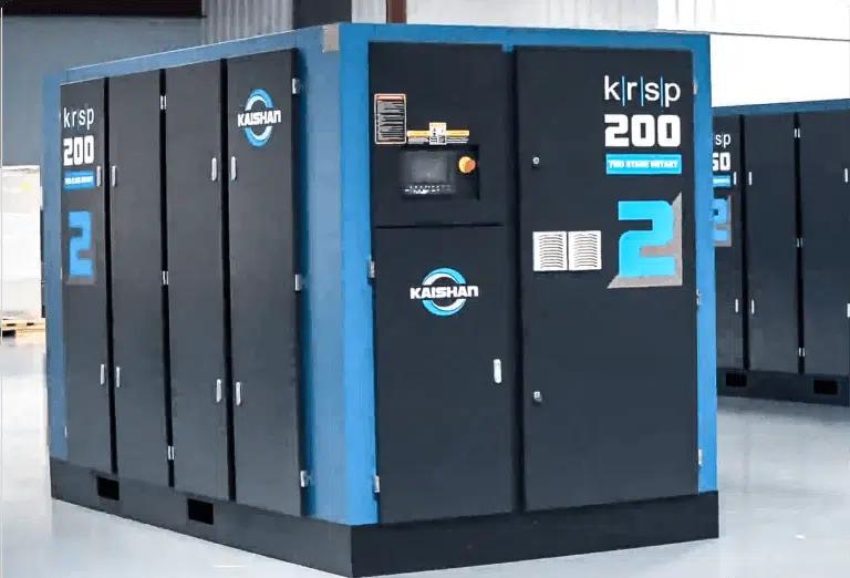 Industrial Kaishan KRSP 200 rotary screw air compressor unit in a manufacturing facility, featuring a blue and black enclosure with control panel and ventilation panels.